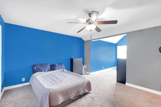 carpeted bedroom with ceiling fan, baseboards, and vaulted ceiling