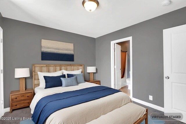 bedroom with carpet, baseboards, and ensuite bathroom