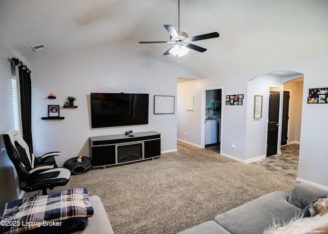 living room with ceiling fan, lofted ceiling, washer / clothes dryer, and carpet