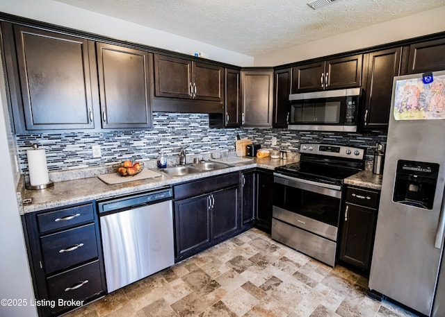 kitchen with stainless steel appliances, dark brown cabinets, sink, and decorative backsplash