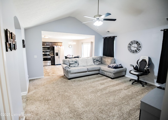 living room featuring ceiling fan with notable chandelier, light colored carpet, and vaulted ceiling