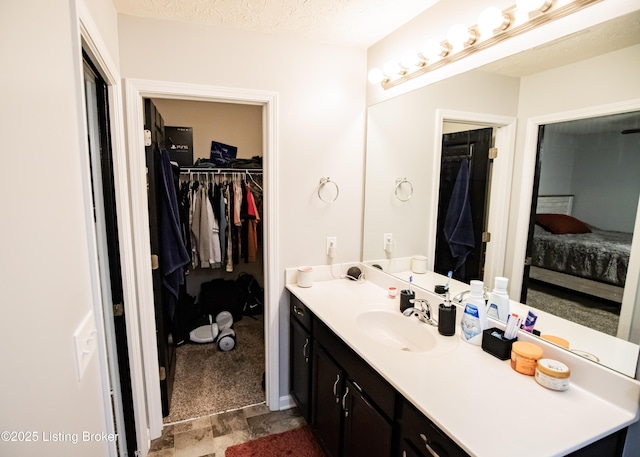 bathroom with vanity and a textured ceiling