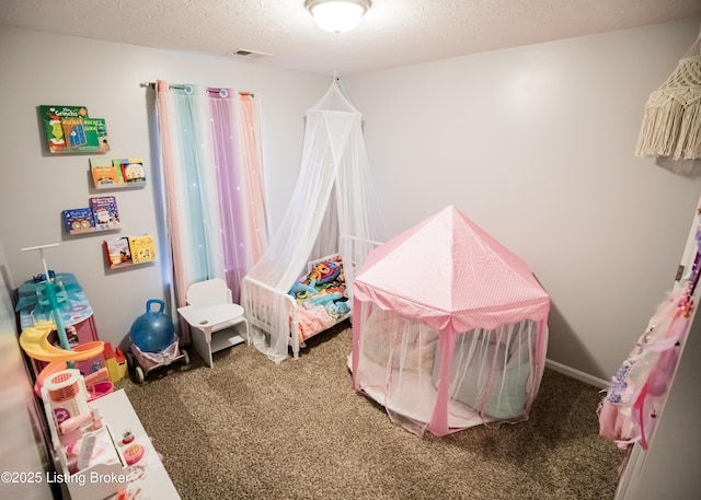 recreation room with carpet flooring and a textured ceiling