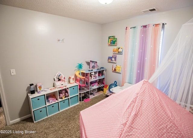 bedroom featuring carpet floors and a textured ceiling