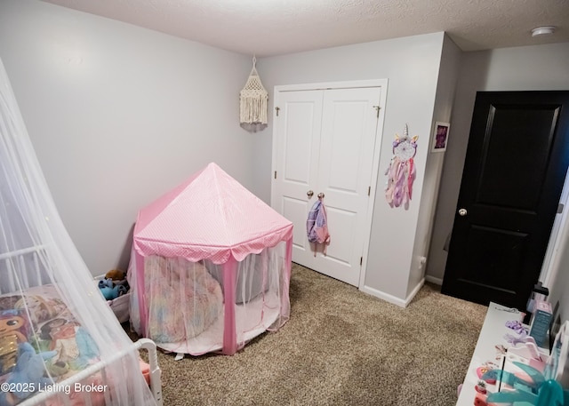 bedroom featuring a closet, a textured ceiling, and carpet