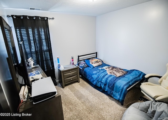 carpeted bedroom featuring a textured ceiling