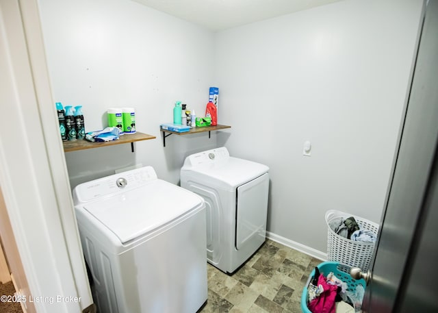 clothes washing area with separate washer and dryer