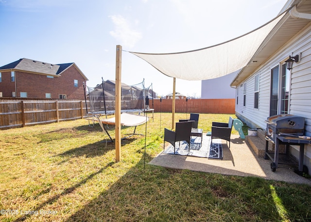 view of yard with a patio and a trampoline