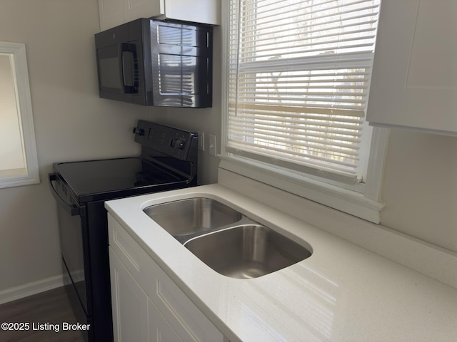 clothes washing area with sink