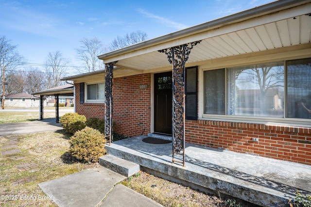 doorway to property with a carport