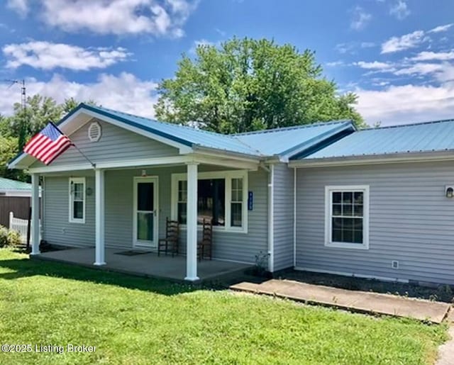 back of house featuring a lawn and a porch