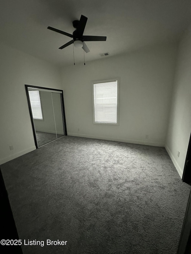 unfurnished bedroom with a closet, carpet flooring, visible vents, and baseboards