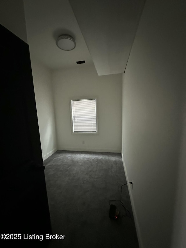 carpeted empty room with visible vents and baseboards