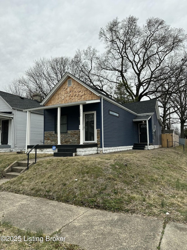 view of front of property with a porch and a front lawn