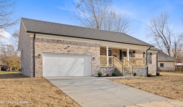 view of front facade featuring a porch and a garage