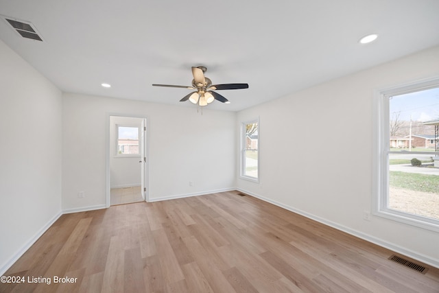 empty room with ceiling fan and light wood-type flooring