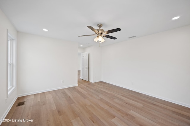 spare room featuring light hardwood / wood-style floors and ceiling fan