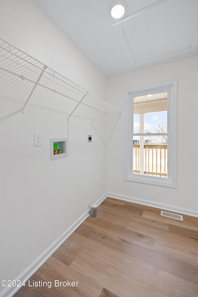 laundry area featuring hardwood / wood-style flooring, electric dryer hookup, and washer hookup