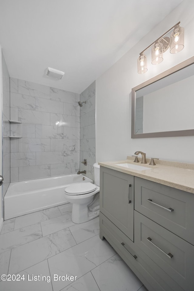 full bathroom featuring vanity, tiled shower / bath combo, and toilet