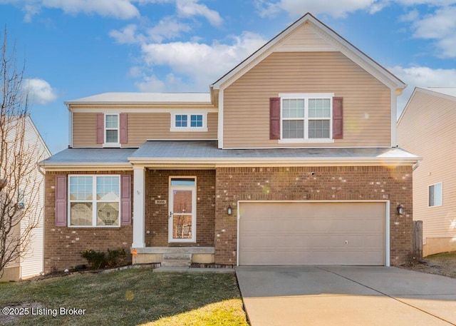 traditional-style home with a garage, concrete driveway, a front yard, and brick siding