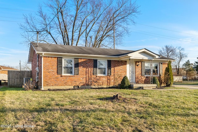 ranch-style home featuring a front yard and central AC unit