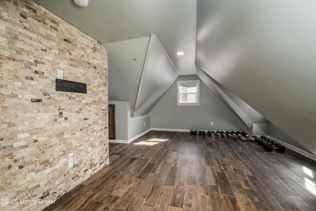 additional living space featuring lofted ceiling and dark wood-type flooring