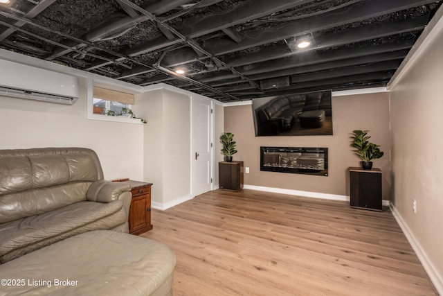 living room featuring light hardwood / wood-style flooring and an AC wall unit