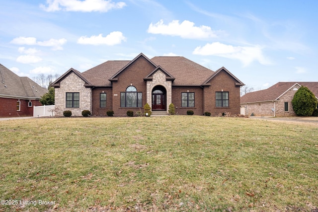 french country home featuring a front lawn