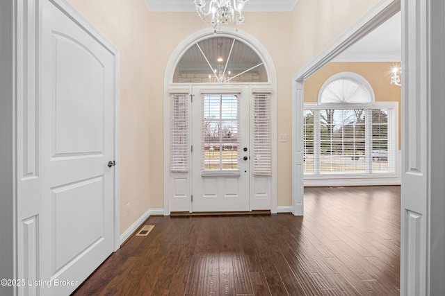 entrance foyer featuring ornamental molding, a chandelier, and a healthy amount of sunlight