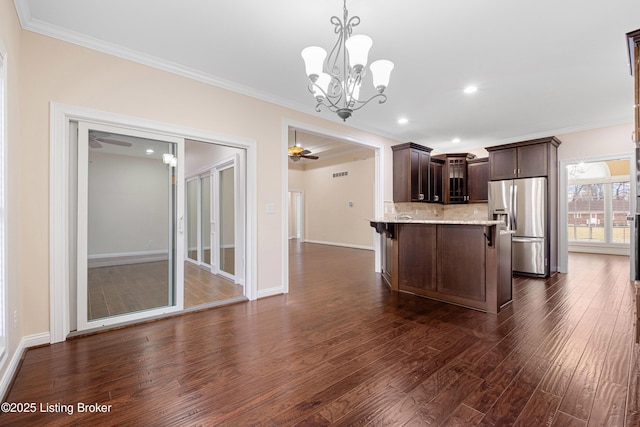 kitchen featuring dark hardwood / wood-style floors, decorative light fixtures, stainless steel fridge with ice dispenser, dark brown cabinetry, and decorative backsplash