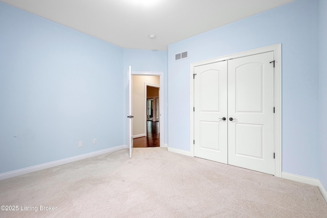 unfurnished bedroom featuring carpet floors and a closet