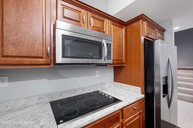 kitchen with stainless steel appliances and light stone countertops