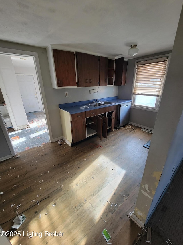 kitchen featuring dark brown cabinets, sink, and light hardwood / wood-style flooring