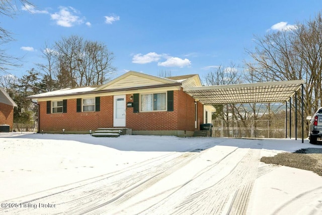 single story home featuring central AC and brick siding