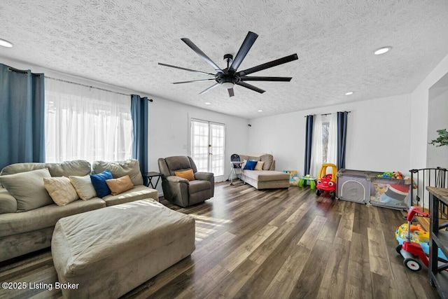 living area with a textured ceiling, a ceiling fan, wood finished floors, and recessed lighting