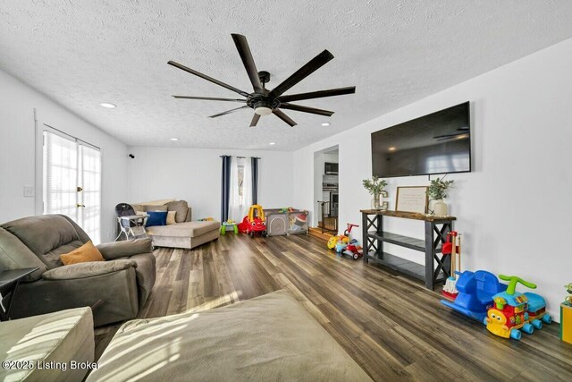 living area featuring a ceiling fan, recessed lighting, a textured ceiling, and wood finished floors