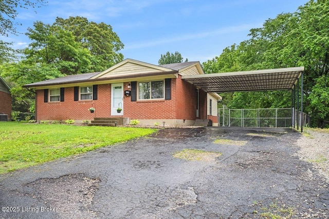 9828 Titan Dr, Louisville, KY 40229 - single story home featuring asphalt driveway, a carport, and brick siding