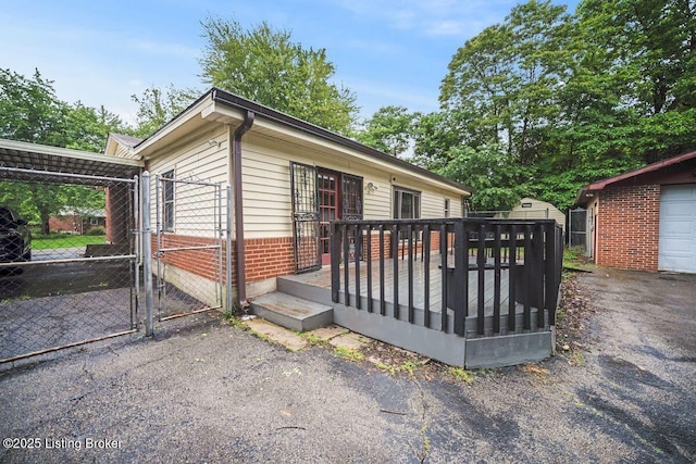 9828 Titan Dr, Louisville, KY 40229 - view of front of property with brick siding, a gate, and a deck
