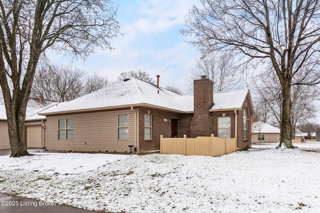 view of snow covered back of property