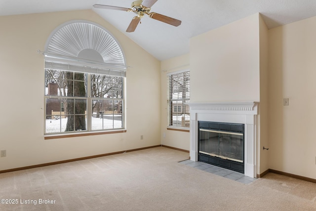 unfurnished living room featuring ceiling fan, light colored carpet, and lofted ceiling