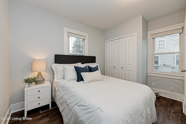 bedroom with dark wood-type flooring, a closet, and a textured ceiling
