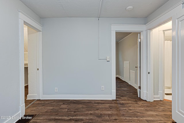 unfurnished bedroom featuring dark wood-type flooring and a textured ceiling