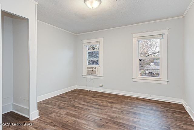 empty room featuring crown molding, dark hardwood / wood-style floors, and a textured ceiling