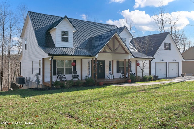 view of front of home with a garage, central AC unit, a porch, metal roof, and a front lawn