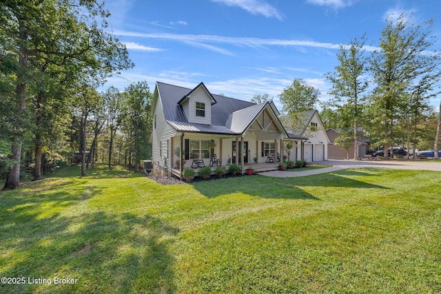 view of front of home featuring covered porch, metal roof, and a front lawn