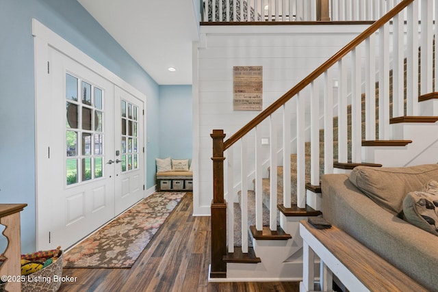 foyer featuring recessed lighting, stairs, wood finished floors, and french doors