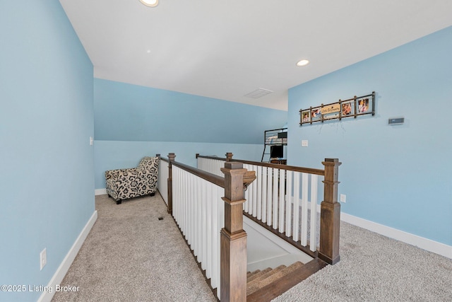 corridor with carpet floors, recessed lighting, baseboards, and an upstairs landing