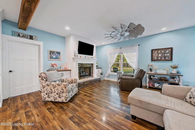 living room featuring dark wood-style floors, ceiling fan, a stone fireplace, and recessed lighting