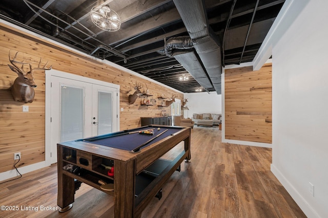 playroom featuring pool table, french doors, wood finished floors, and wooden walls