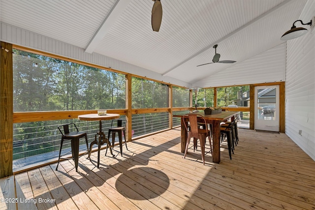 sunroom featuring lofted ceiling and a ceiling fan